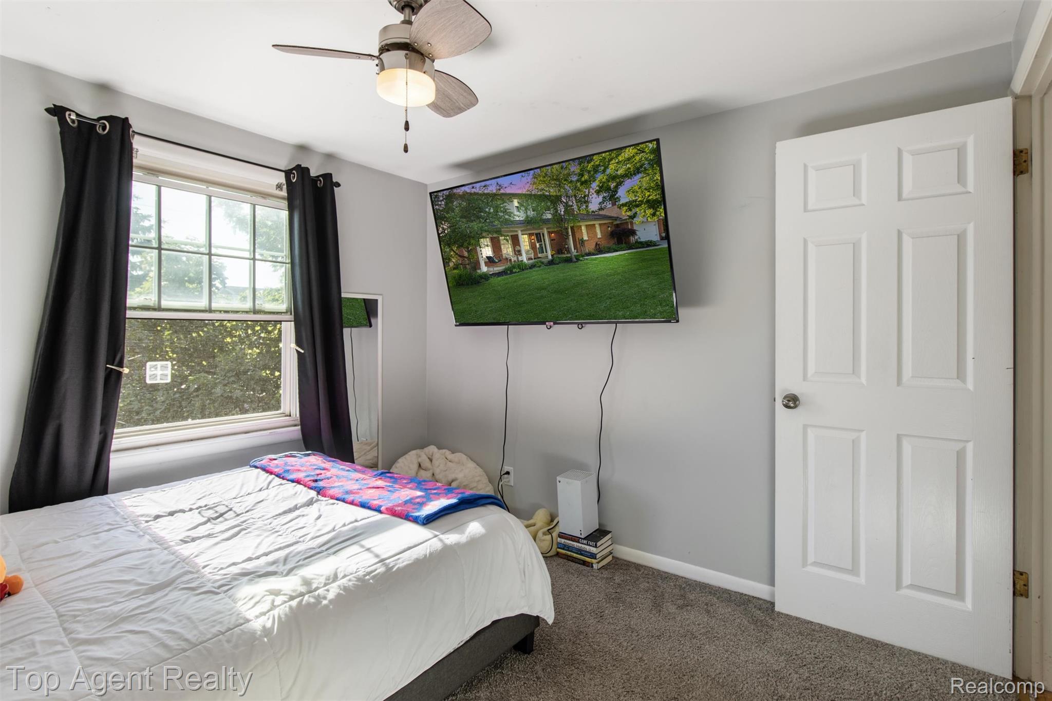 32341 Woody Road Fraser, MI 48026 - Photo 30 of 47 Bedroom featuring a ceiling fan with light fixture, window with exterior foliage, and panel door