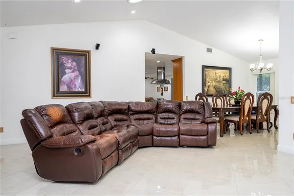 a living room with furniture and a ceiling fan
