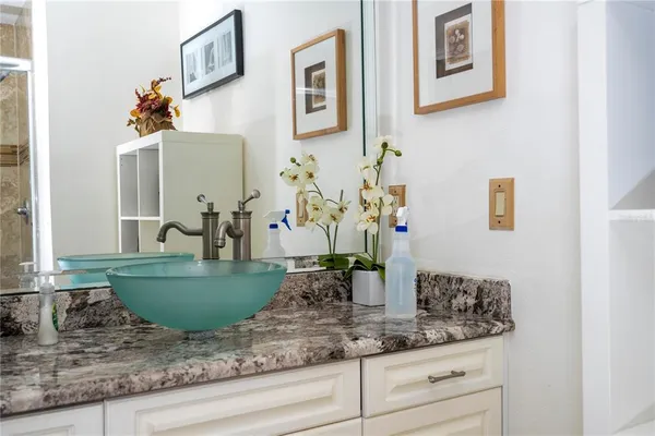 a living room with furniture kitchen view and a chandelier