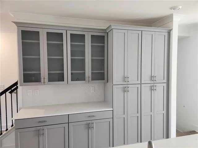 a large kitchen with stainless steel appliances kitchen island granite countertop a stove a sink and a refrigerator