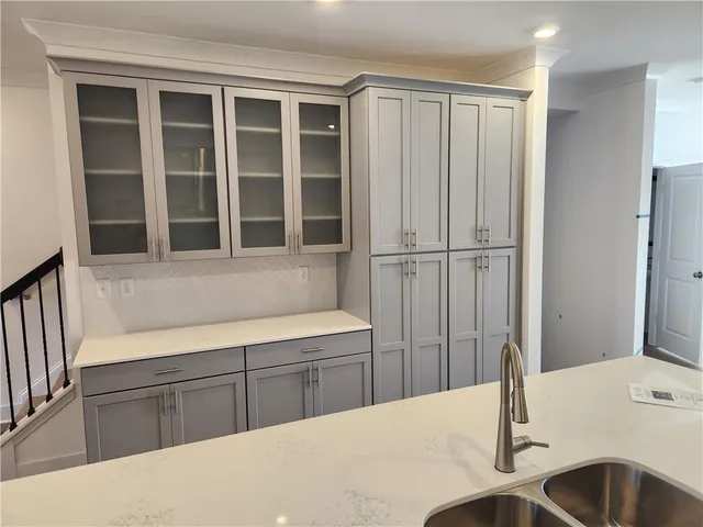 a room with a fireplace and cabinets