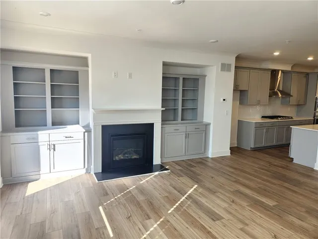 a view of a living room kitchen and a wooden floor