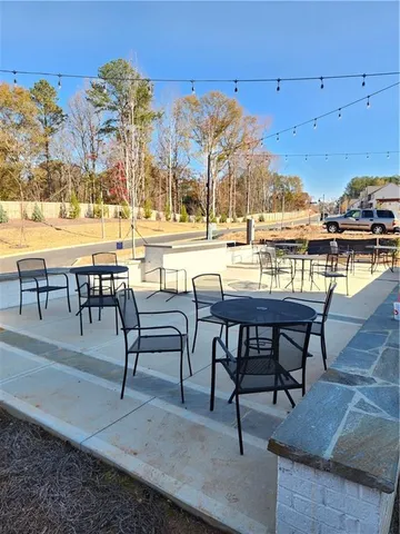 a view of a swimming pool with a yard and sitting area