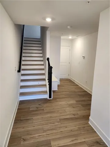 a view of entryway with wooden floor and stairs