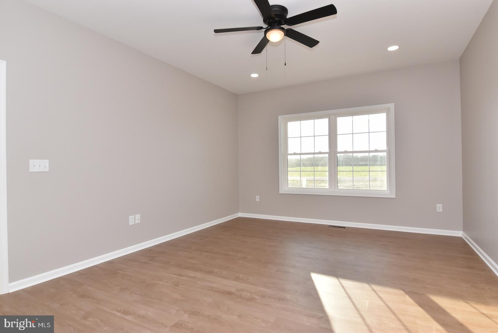 34327 Branch School Road Laurel, DE 19956 - Photo 14 of 23 an empty room with windows and fan