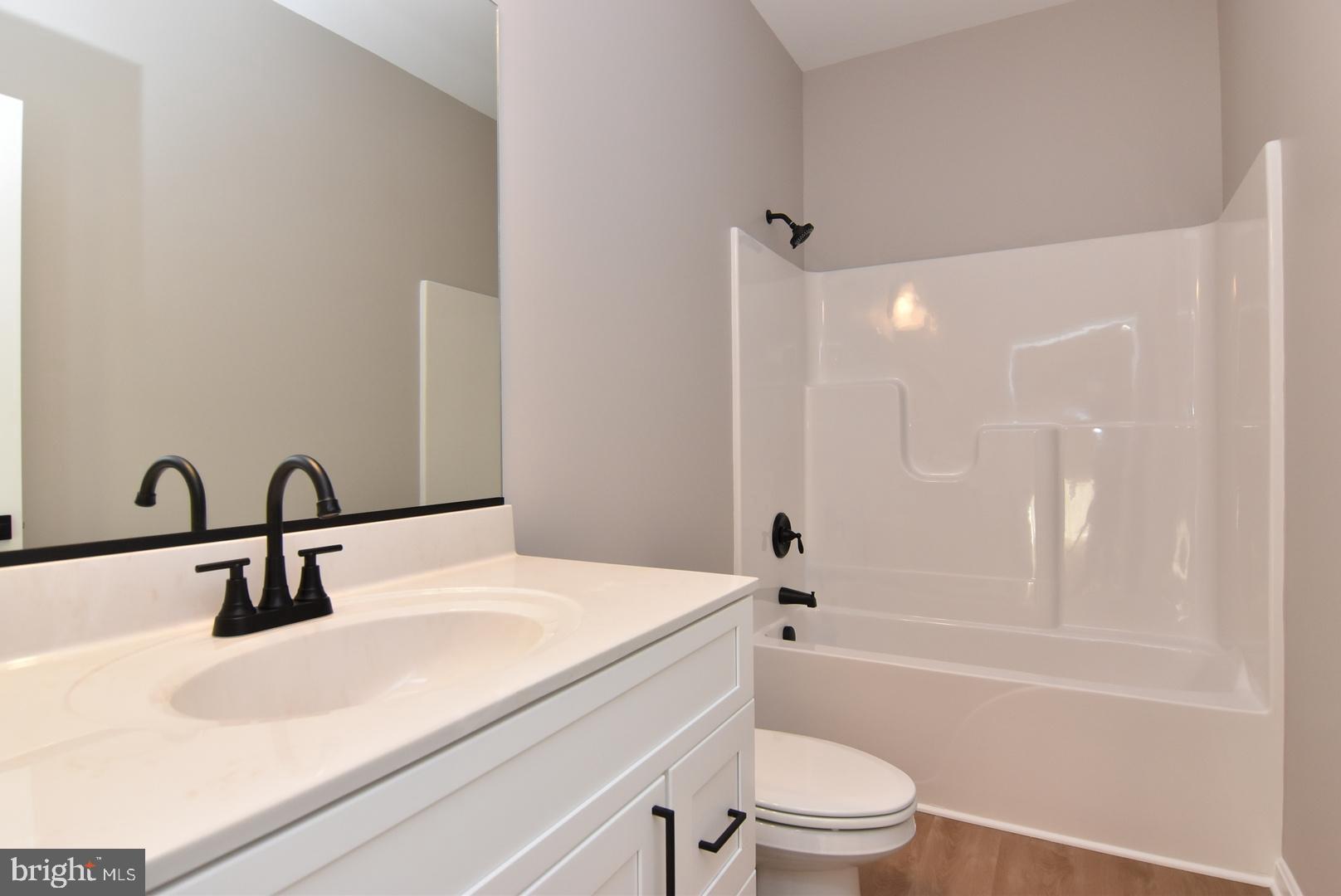 34327 Branch School Road Laurel, DE 19956 - Photo 17 of 23 a bathroom with a sink a toilet and a large mirror