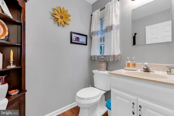 a bathroom with a sink toilet and a mirror