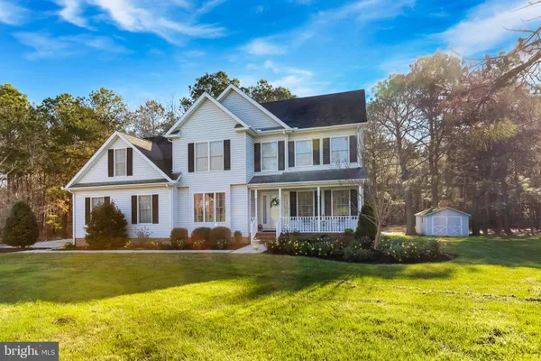a front view of a house with swimming pool and porch