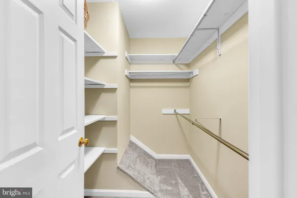 a view of staircase with white walls and a window