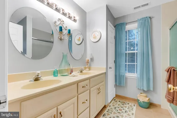 a bathroom with a double vanity sink and a mirror