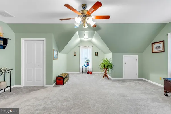 a view of a livingroom with a ceiling fan and a large window
