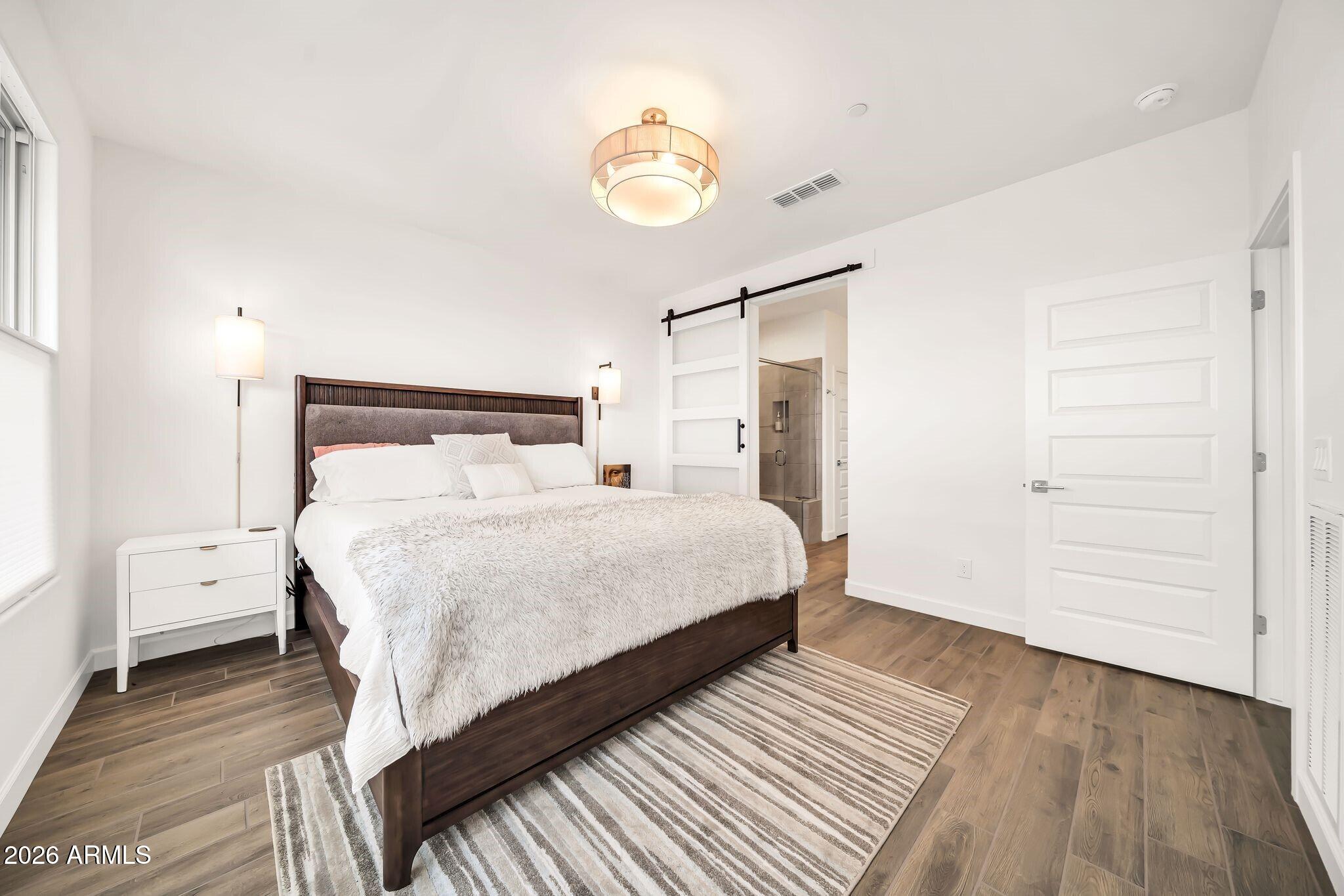 18221 East Spring Valley Court Rio Verde, AZ 85263 - Photo 18 of 49 a bedroom with a bed and a chandelier
