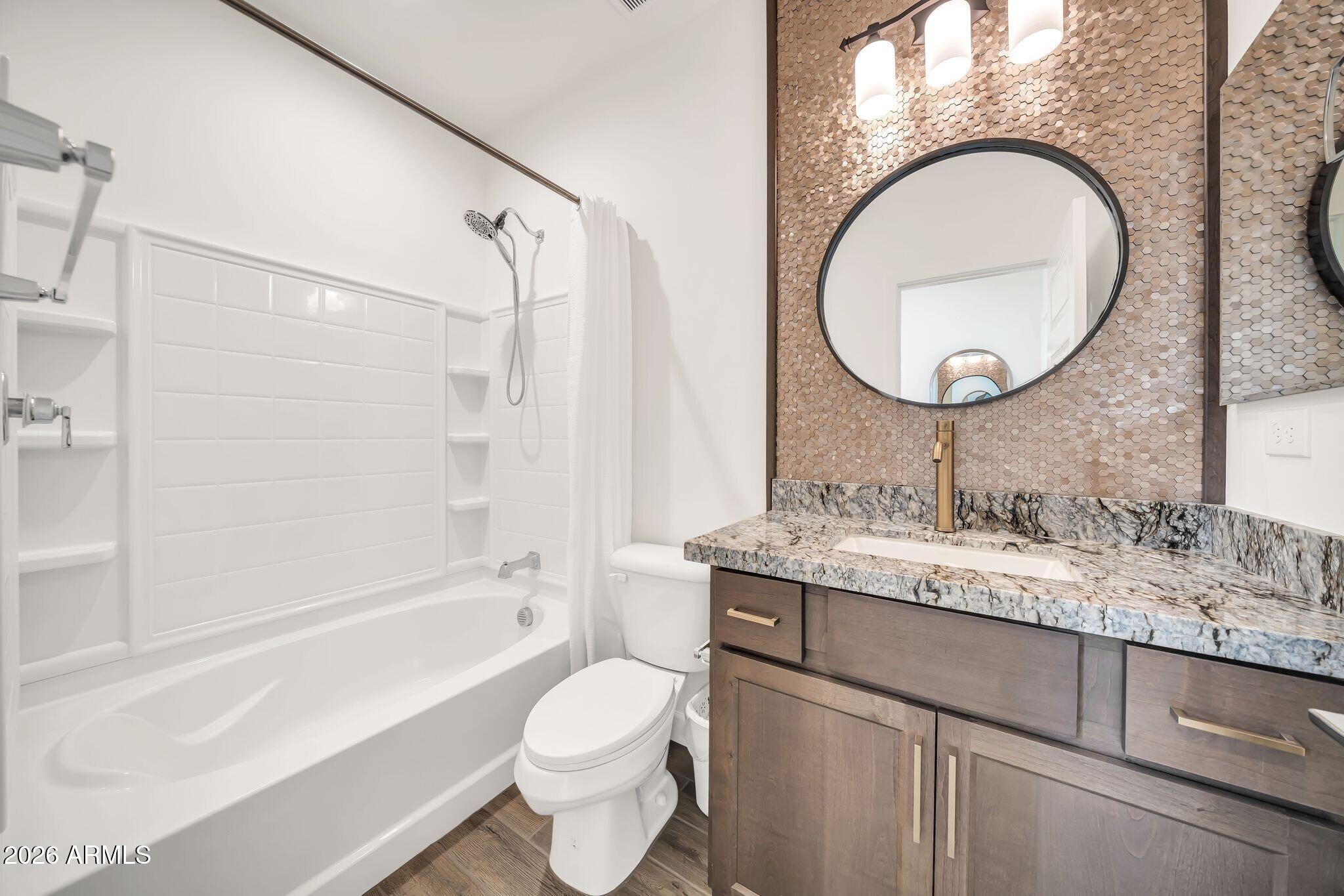 18221 East Spring Valley Court Rio Verde, AZ 85263 - Photo 25 of 49 a bathroom with a granite countertop toilet sink and mirror