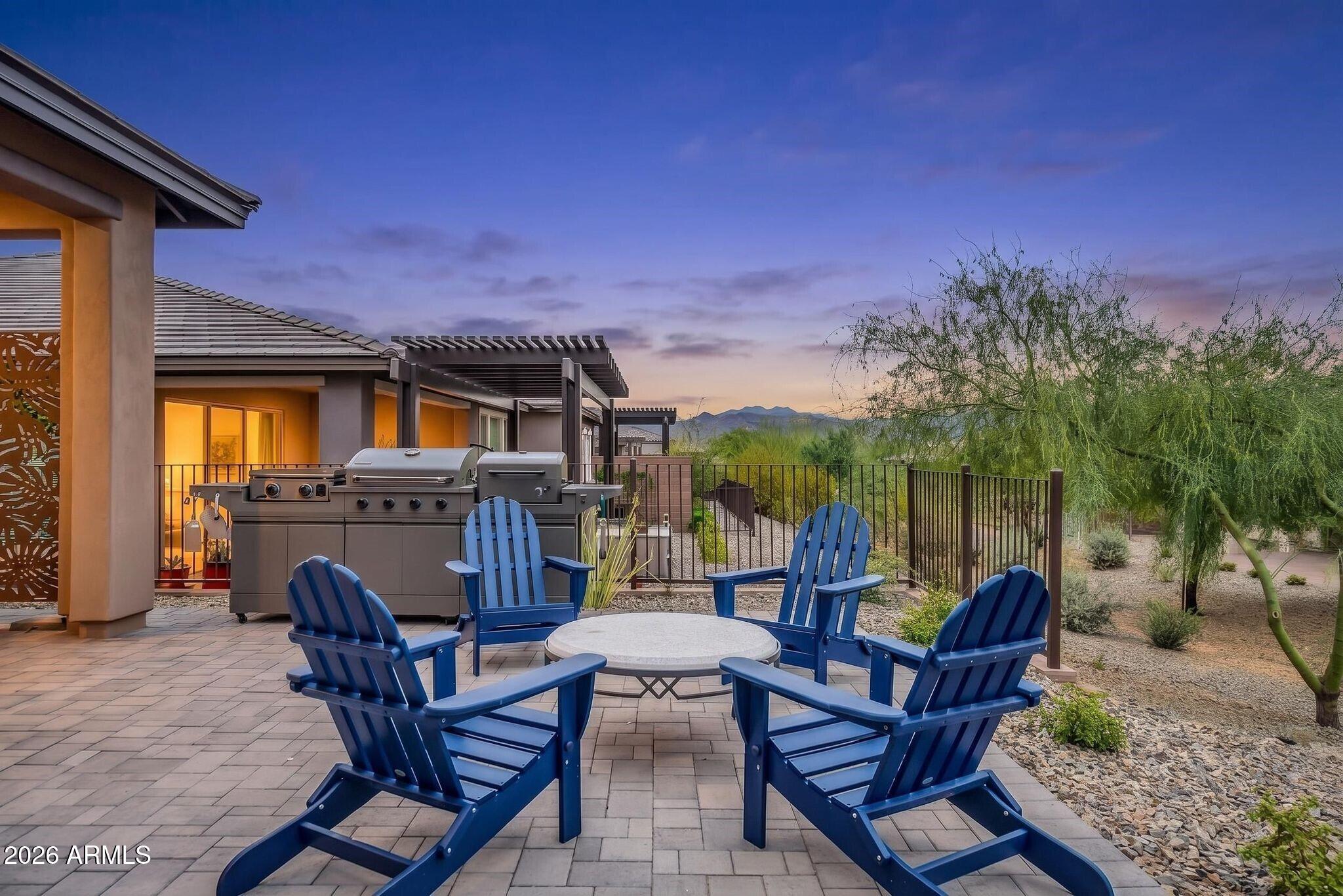 18221 East Spring Valley Court Rio Verde, AZ 85263 - Photo 2 of 49 a view of a patio with table and chairs with wooden floor and fence