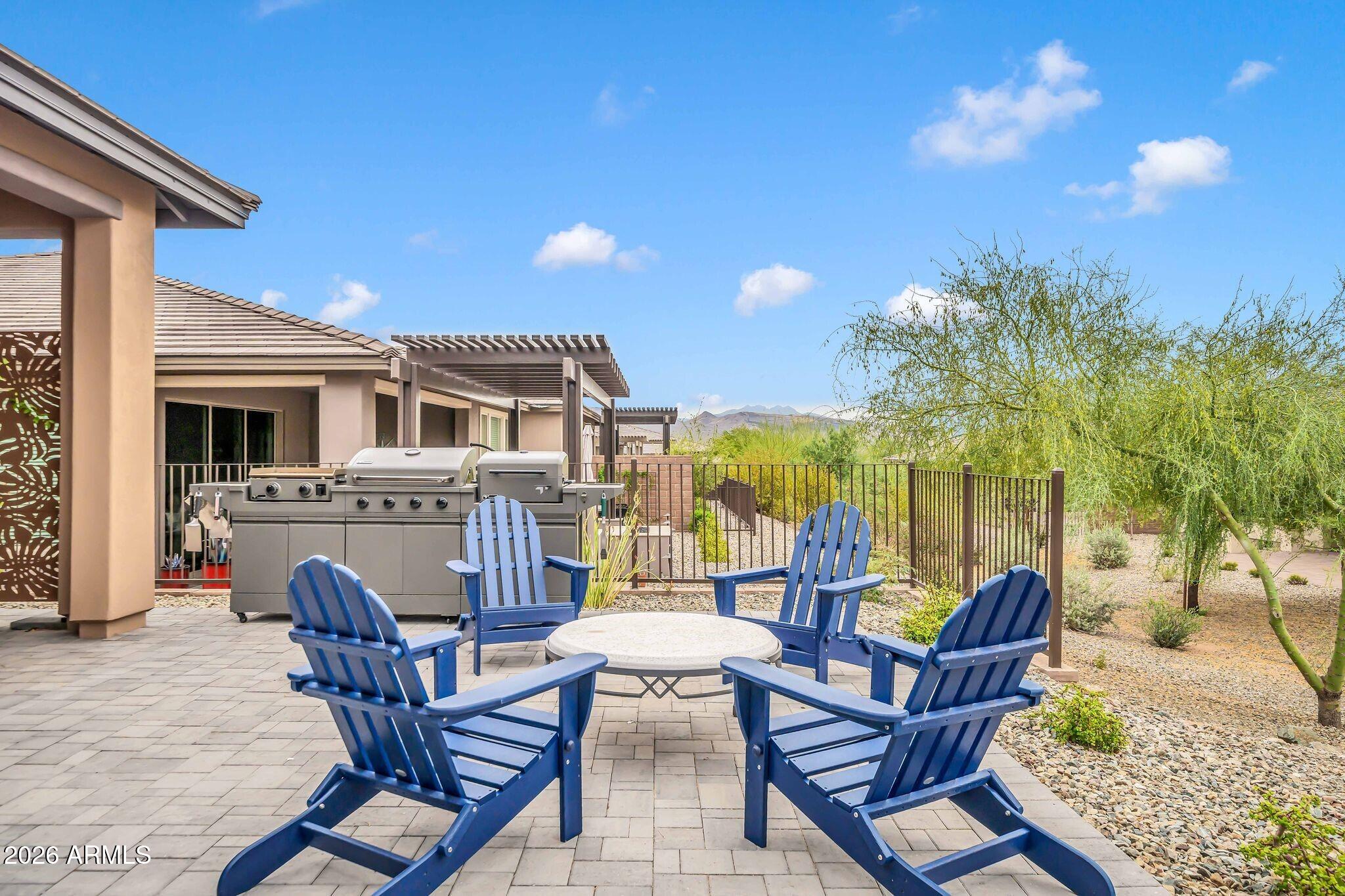 18221 East Spring Valley Court Rio Verde, AZ 85263 - Photo 29 of 49 a view of a patio with table and chairs with wooden floor and fence