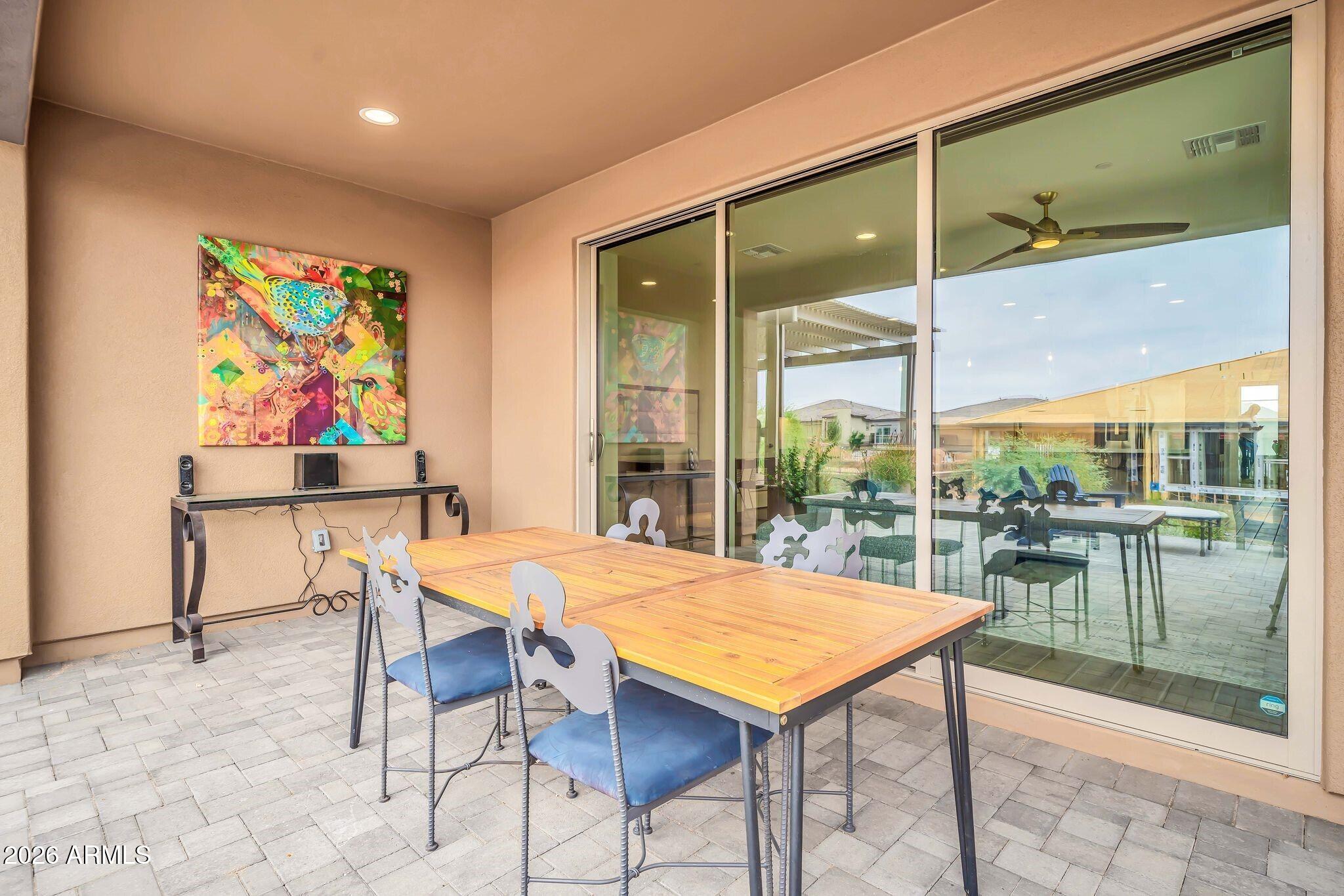 18221 East Spring Valley Court Rio Verde, AZ 85263 - Photo 33 of 49 a view of a dining room with furniture large windows and wooden floor