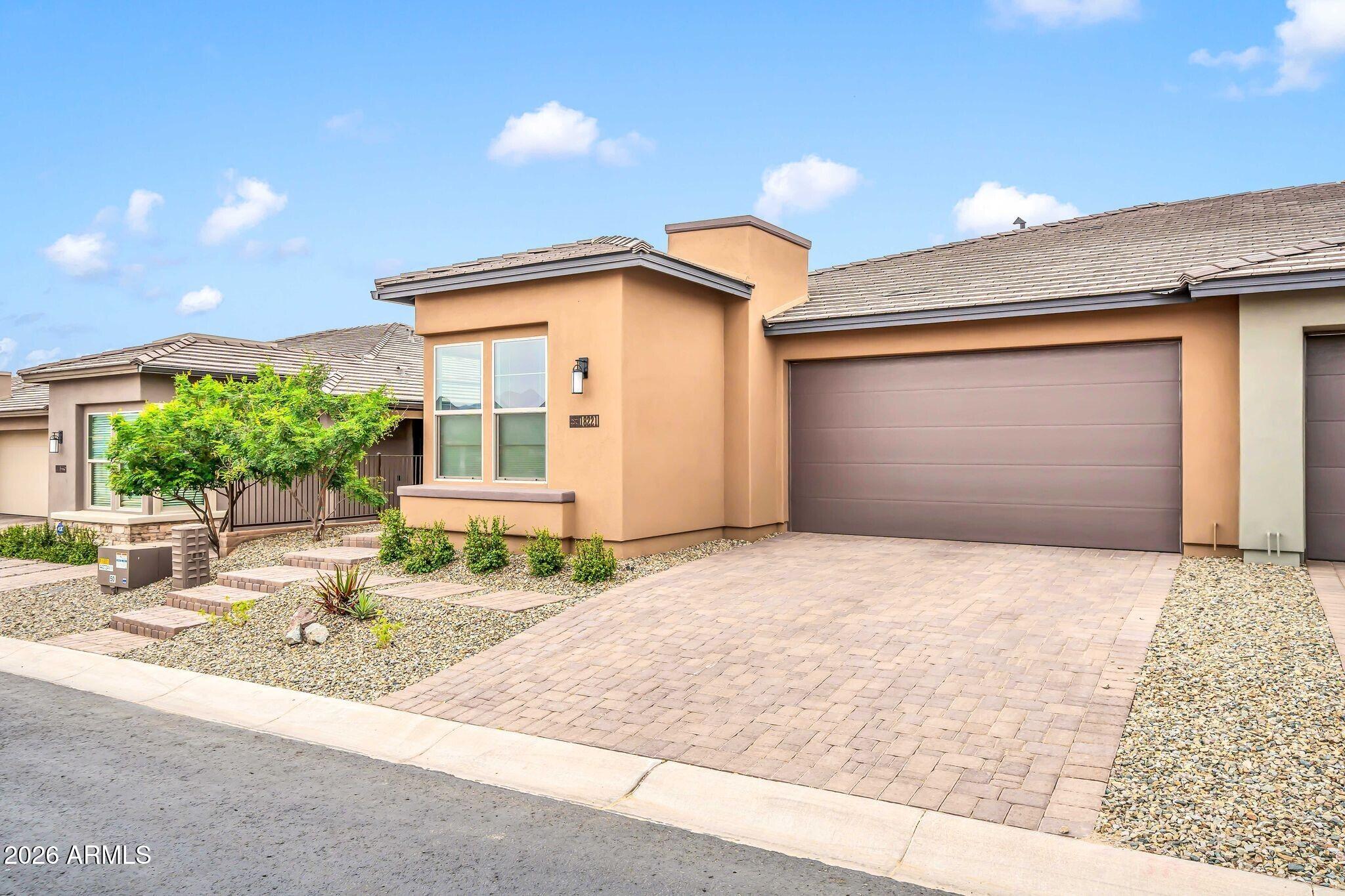 18221 East Spring Valley Court Rio Verde, AZ 85263 - Photo 4 of 49 a front view of a house with a yard and garage