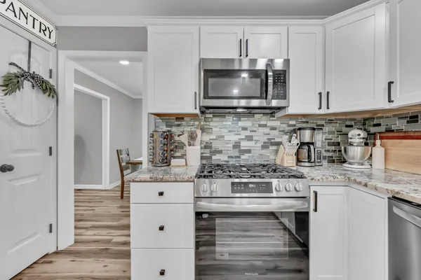 a kitchen with stainless steel appliances a stove and a sink