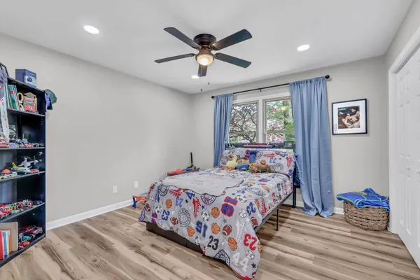 a bedroom with bed and a book shelf