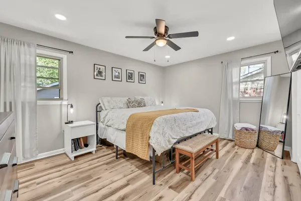 a spacious bedroom with a bed and a window