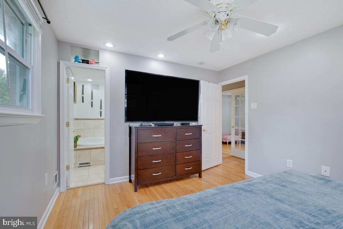 12900 Glynis Road Clinton, MD 20735 - Photo 11 of 38 a bedroom with a bed and a flat screen tv