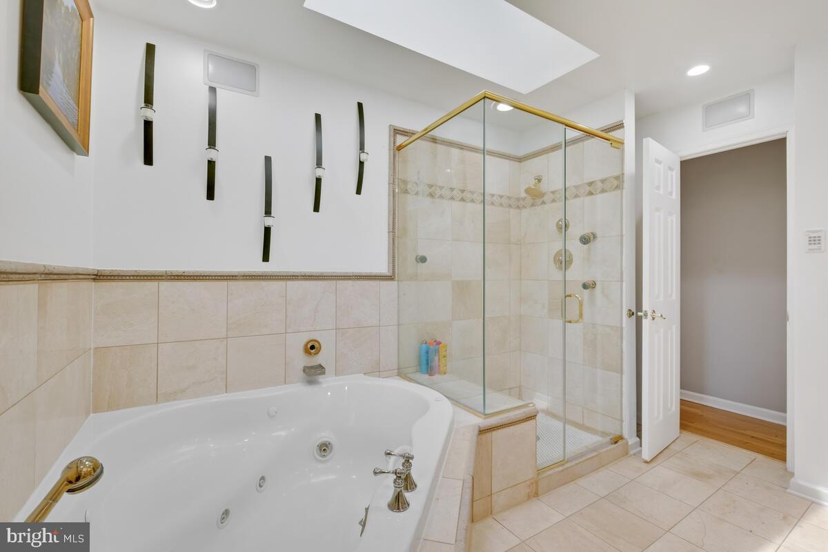 12900 Glynis Road Clinton, MD 20735 - Photo 12 of 38 a bathroom with a tub and a shower