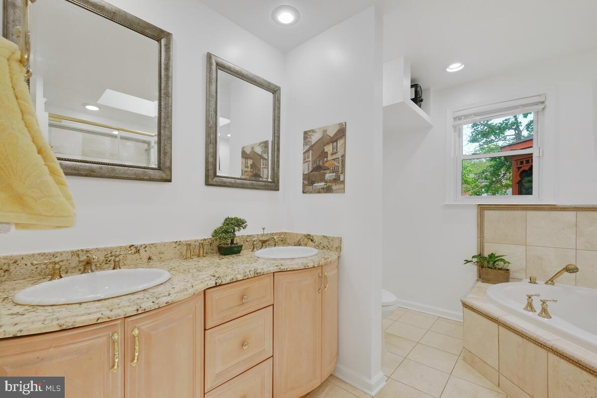 12900 Glynis Road Clinton, MD 20735 - Photo 13 of 38 a bathroom with a granite countertop sink and a mirror