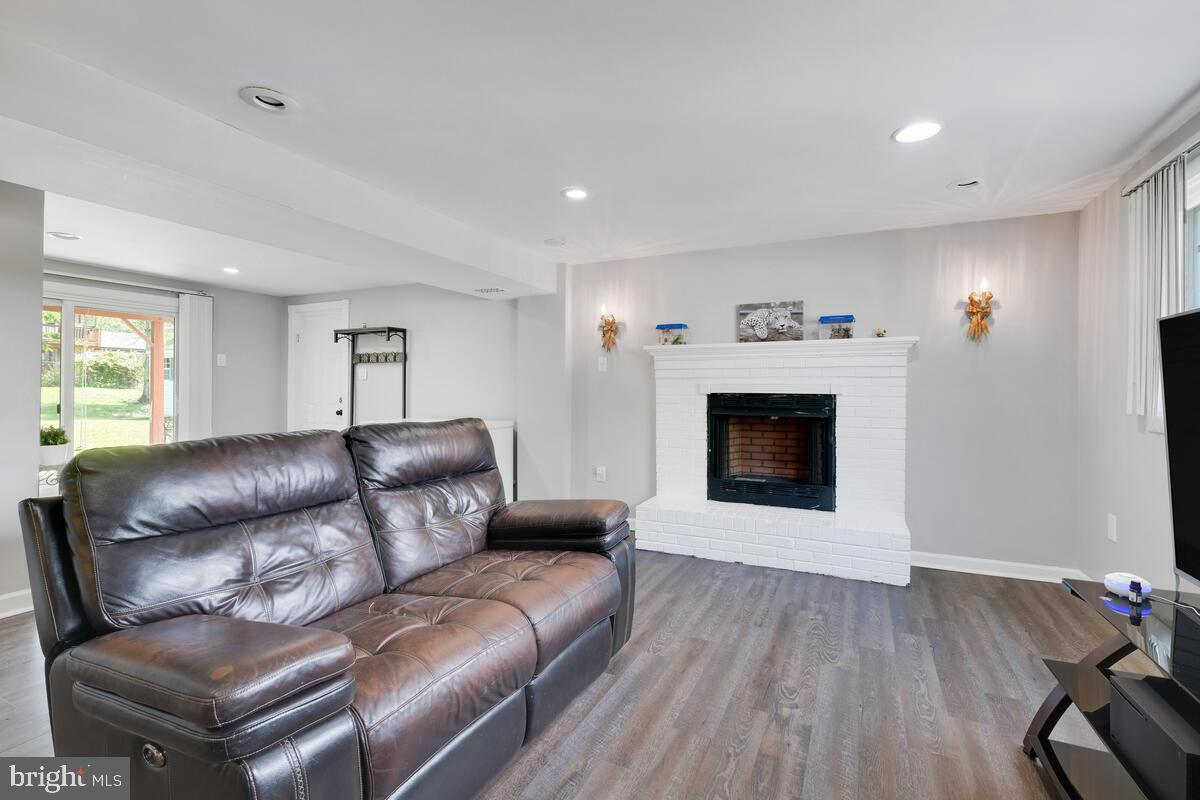 12900 Glynis Road Clinton, MD 20735 - Photo 16 of 38 a living room with furniture and a fireplace