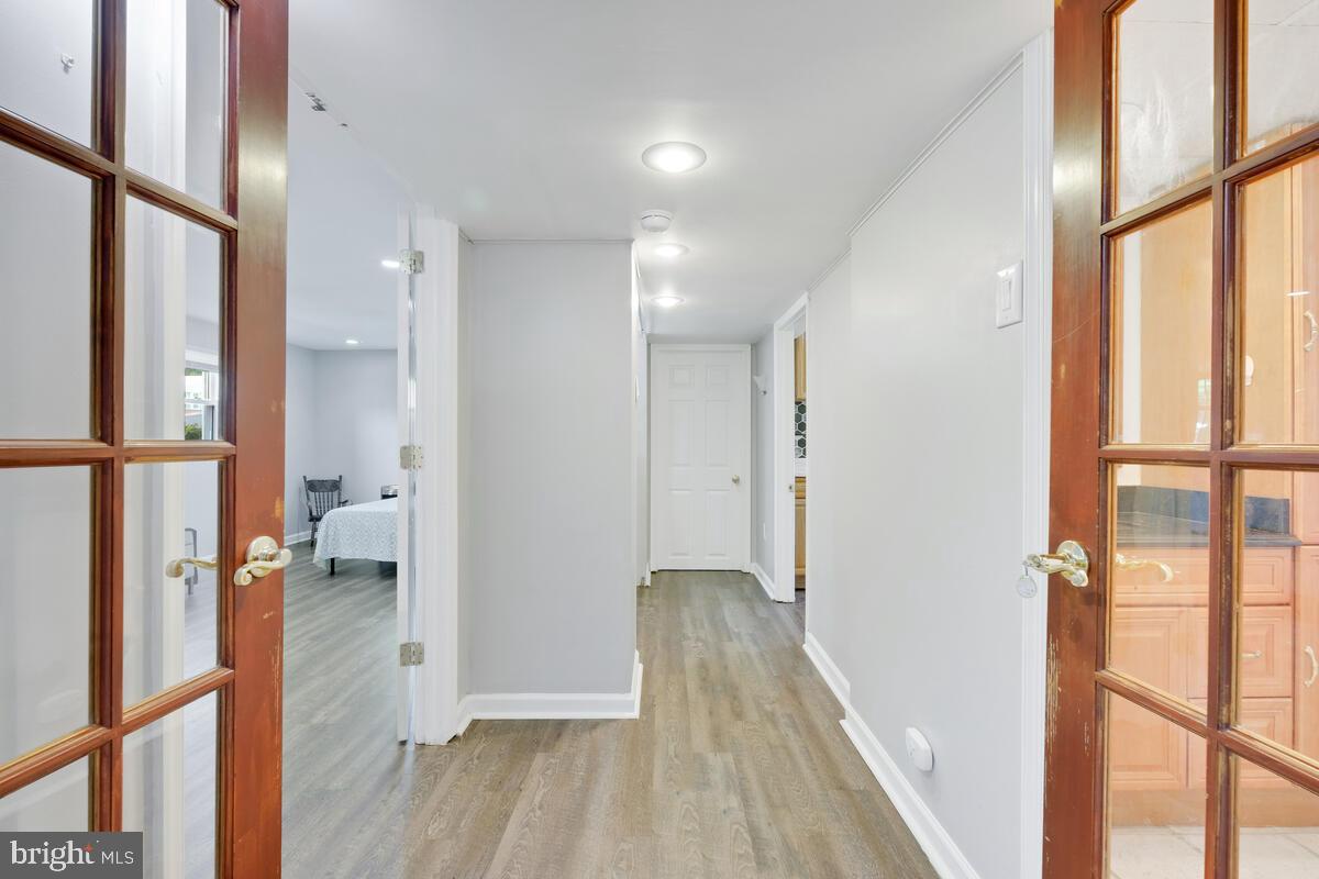 12900 Glynis Road Clinton, MD 20735 - Photo 20 of 38 a view of hallway with wooden floor and a window