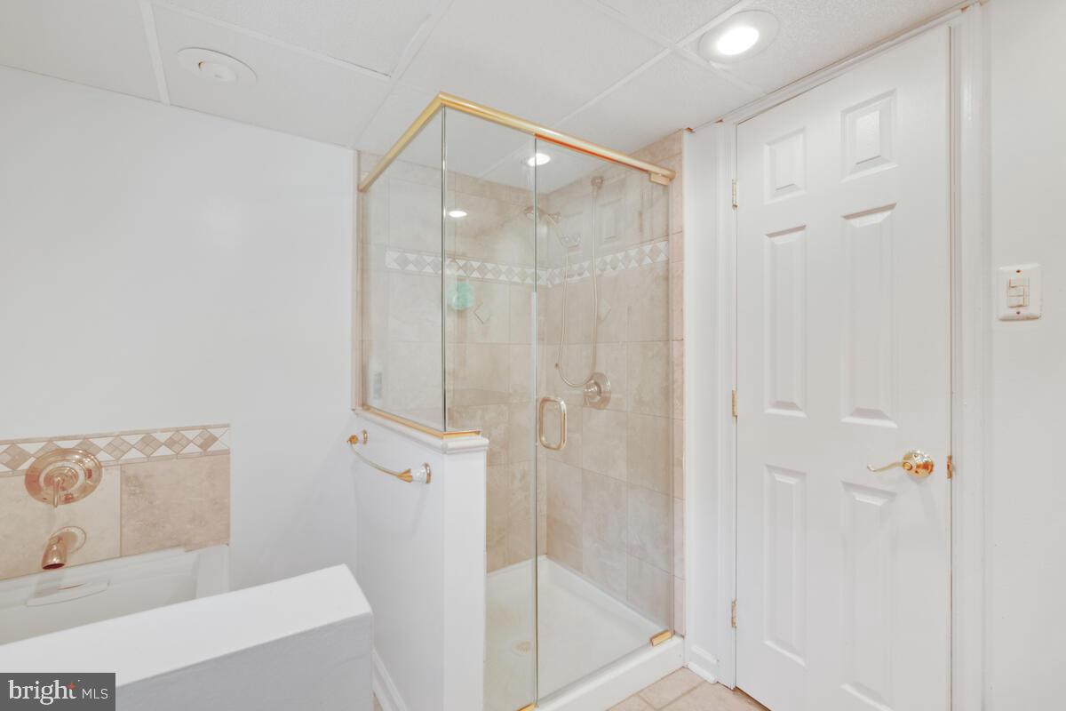 12900 Glynis Road Clinton, MD 20735 - Photo 24 of 38 a bathroom with a glass shower door