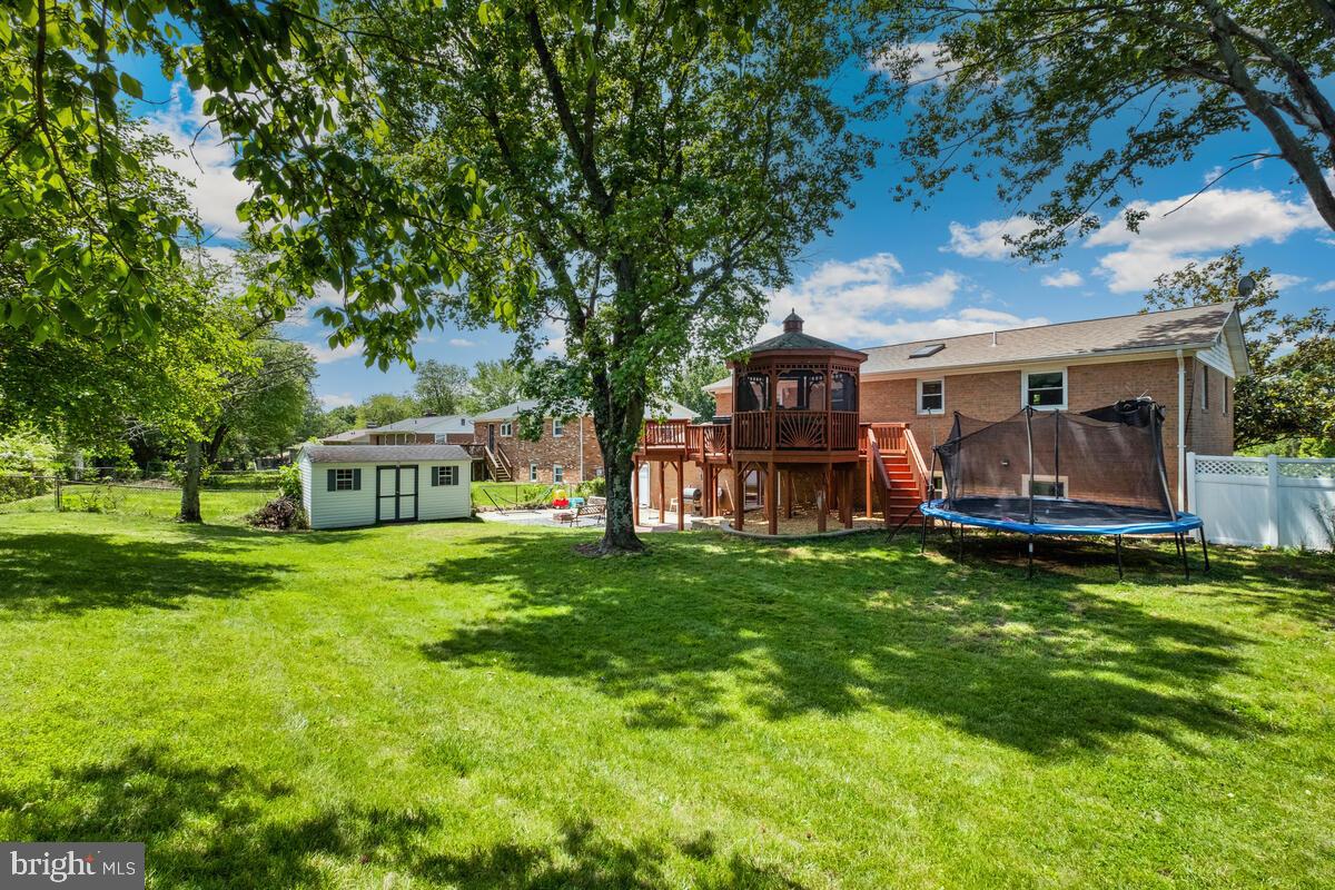 12900 Glynis Road Clinton, MD 20735 - Photo 29 of 38 a view of a house with a backyard