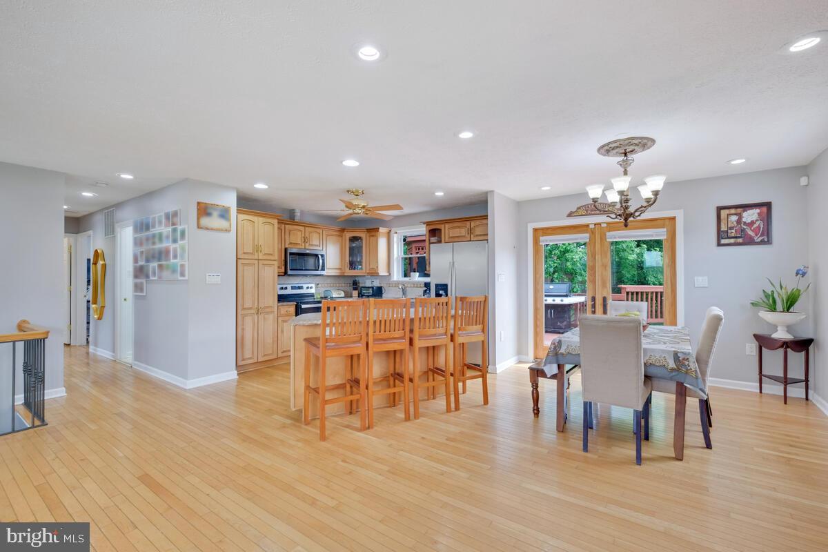 12900 Glynis Road Clinton, MD 20735 - Photo 3 of 38 a dining room with furniture and wooden floor