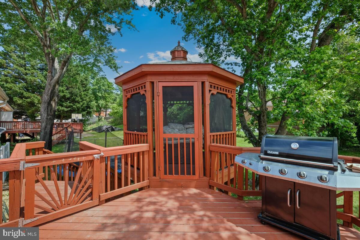 12900 Glynis Road Clinton, MD 20735 - Photo 31 of 38 a view of a deck with wooden floor and iron fence