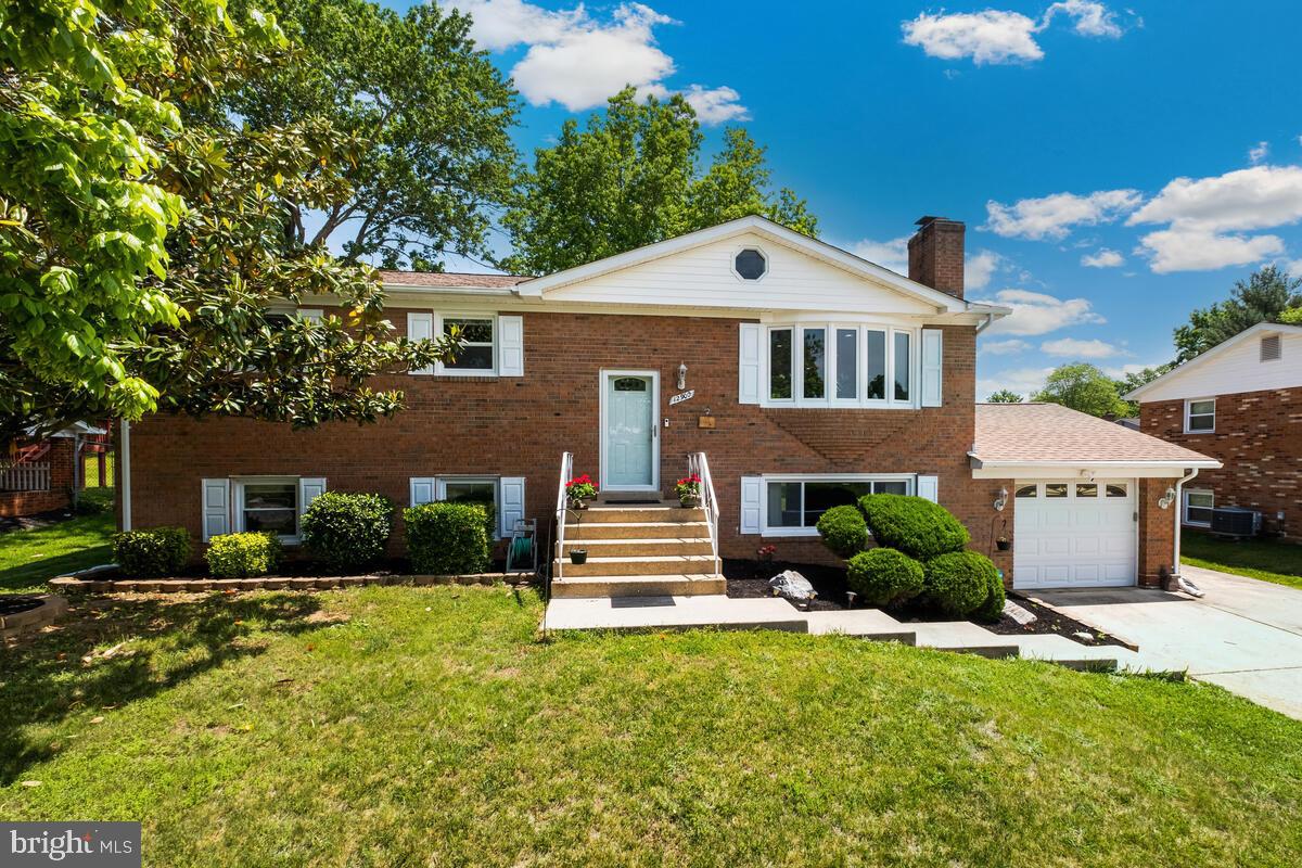 12900 Glynis Road Clinton, MD 20735 - Photo 32 of 38 a front view of a house with a yard