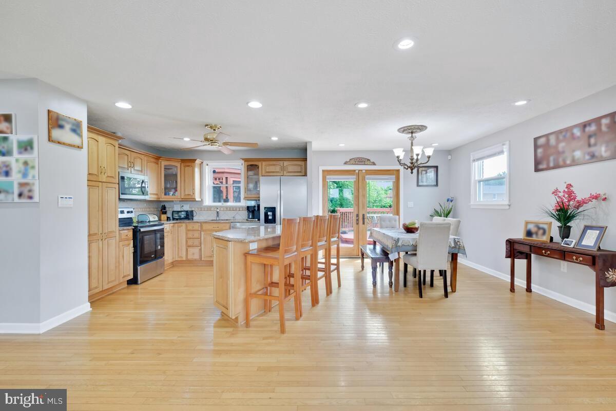 12900 Glynis Road Clinton, MD 20735 - Photo 4 of 38 a view of kitchen dining table room and wooden floor