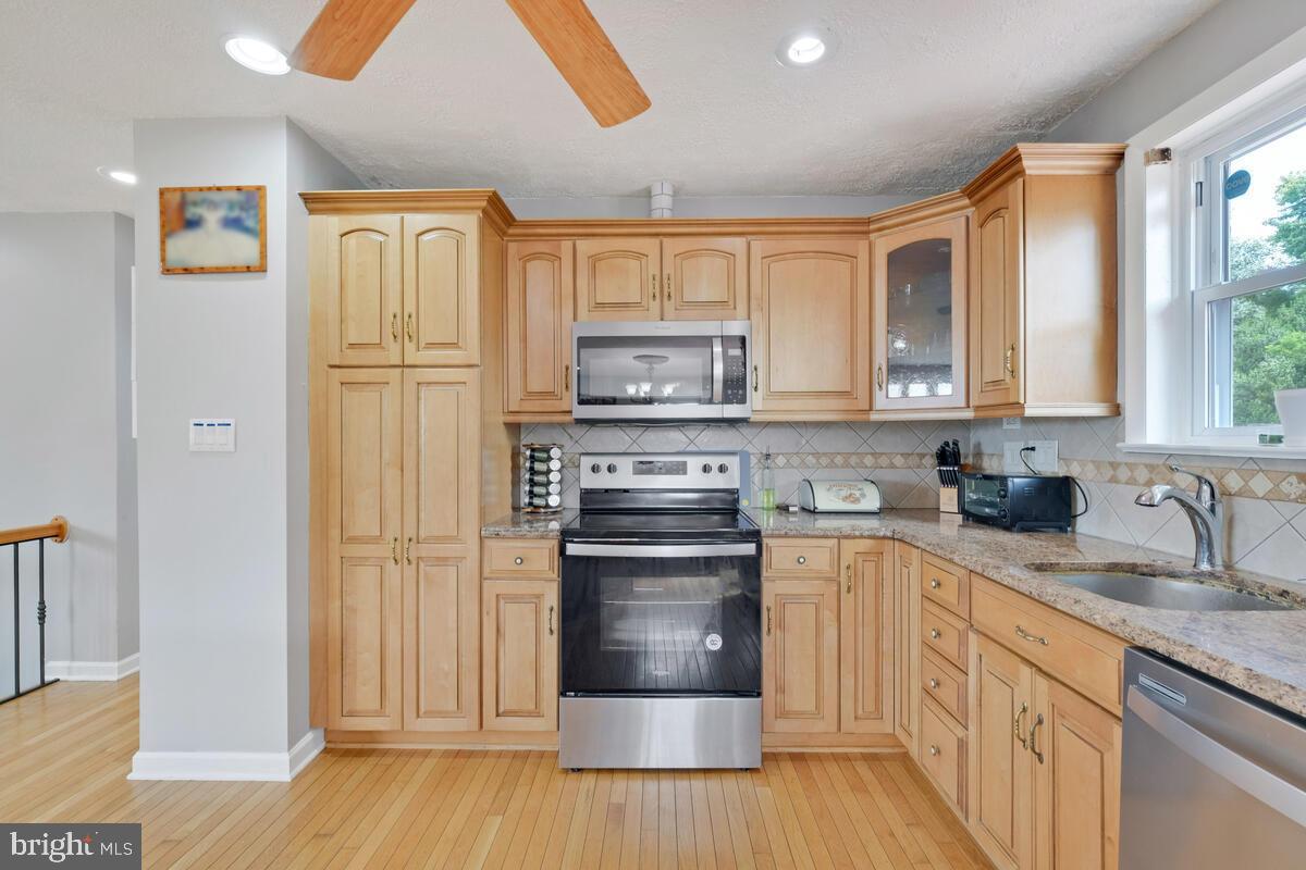 12900 Glynis Road Clinton, MD 20735 - Photo 8 of 38 a kitchen with granite countertop a refrigerator and a sink