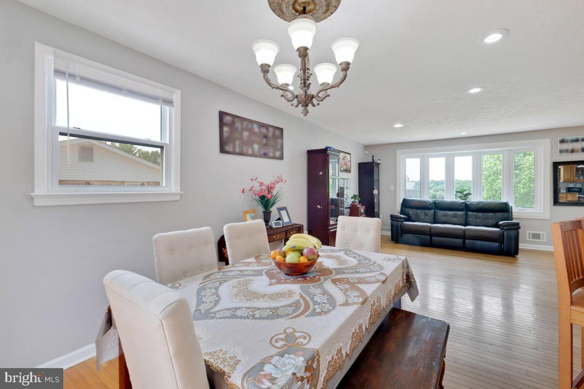 12900 Glynis Road Clinton, MD 20735 - Photo 9 of 38 a living room with furniture and a chandelier