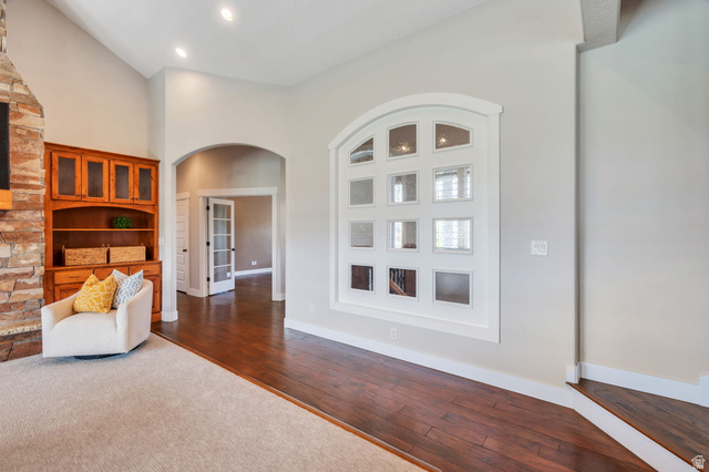 1355 West 1000 South Mapleton, UT 84664 - Photo 15 of 74 Living area featuring arched walkways, a high ceiling, dark wood-style flooring, and recessed lighting