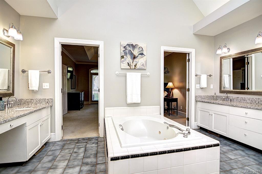 443 Beacon Knoll Lane Fort Mill, SC 29708 - Photo 16 of 24 a spacious bathroom with a granite countertop tub sink and mirror