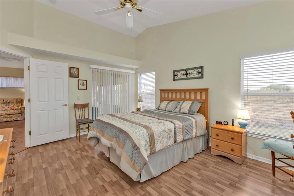 24117 Buckingham Way Punta Gorda, FL 33980 - Photo 16 of 41 a bedroom with a bed and a chandelier