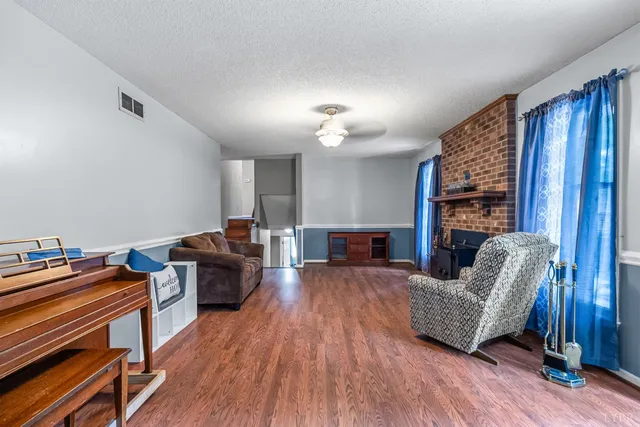 a living room with furniture and wooden floor