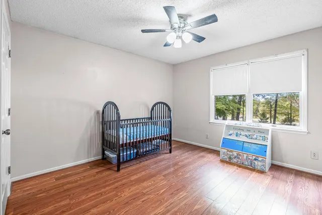 a view of a room with wooden floor and windows