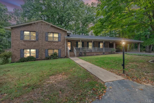 a front view of house with yard and green space