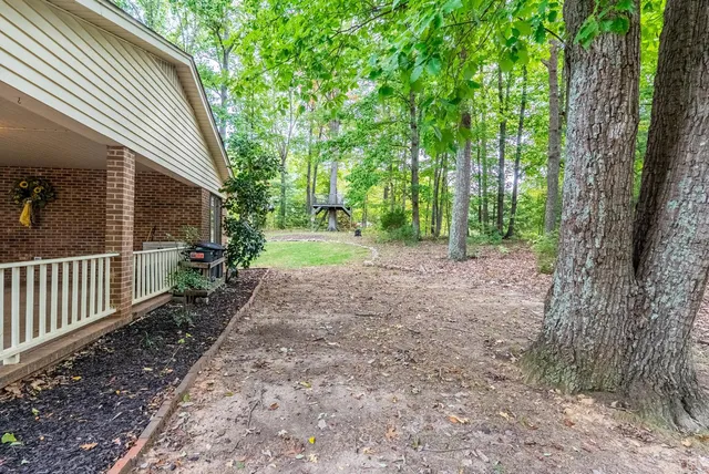 a backyard of a house with yard and trampoline
