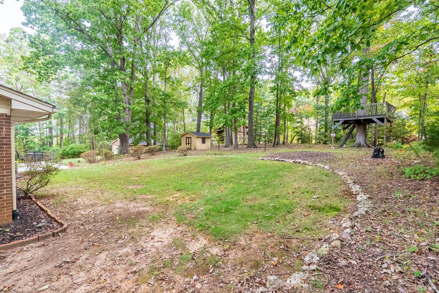 1773 Barker Road Ringgold, VA 24586 - Photo 29 of 40 a backyard of a house with yard and trampoline