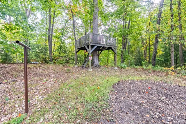 a view of a house with backyard and sitting area