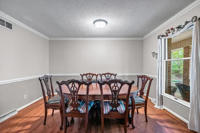a view of a dining room with furniture and wooden floor