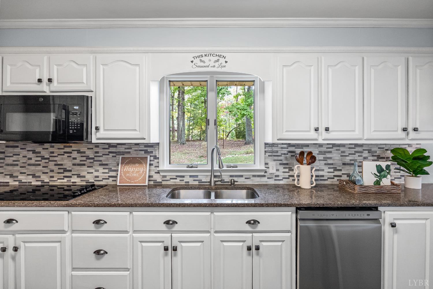 1773 Barker Road Ringgold, VA 24586 - Photo 9 of 40 a kitchen with stainless steel appliances granite countertop white cabinets a window and a sink