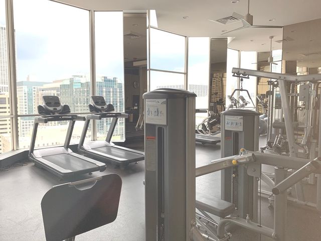 a view of a living room with furniture and a floor to ceiling window