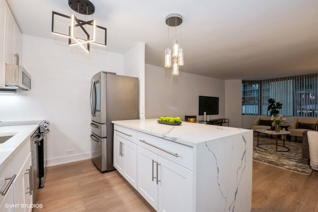 a view of kitchen center island and stainless steel appliances